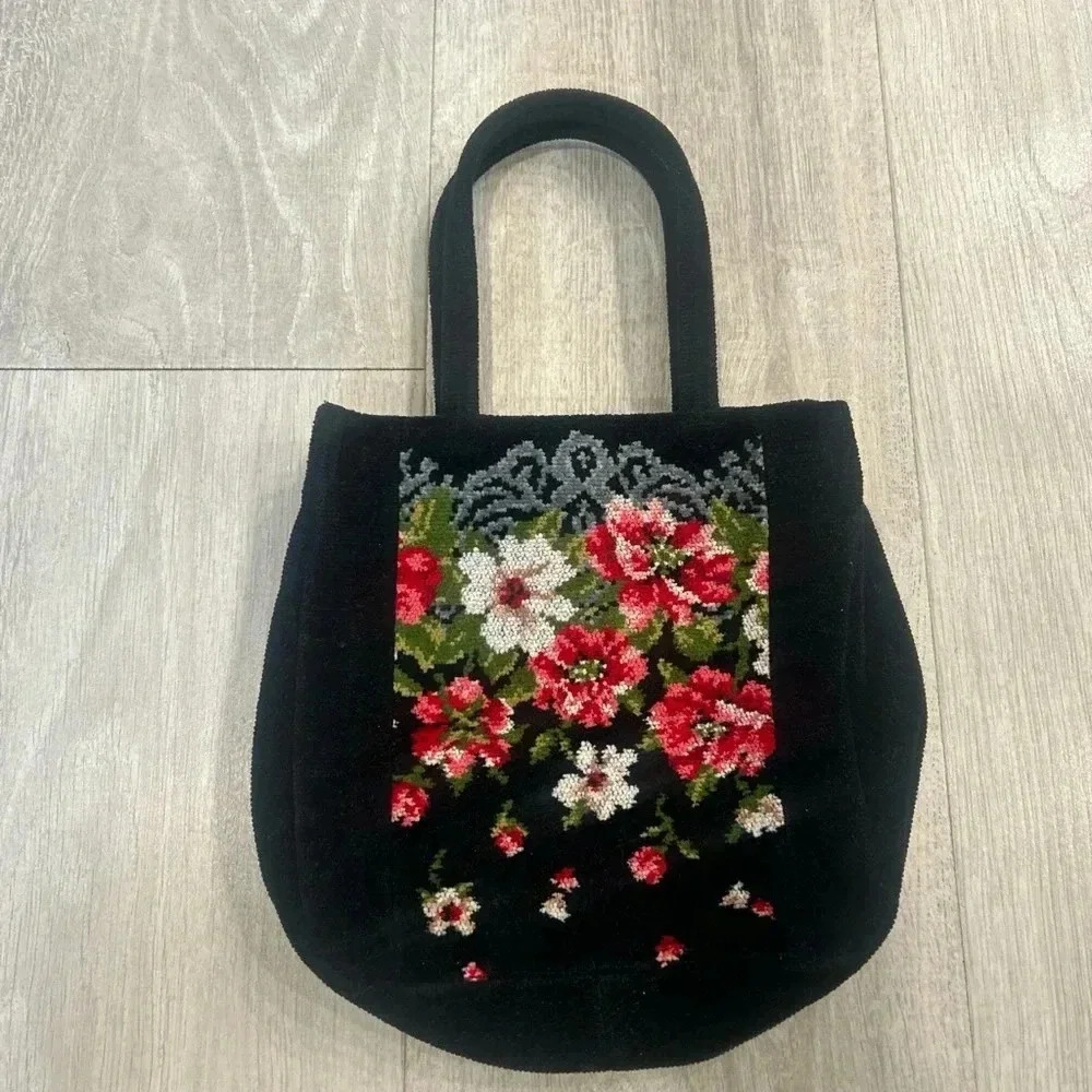 Feiler black and floral print purse.